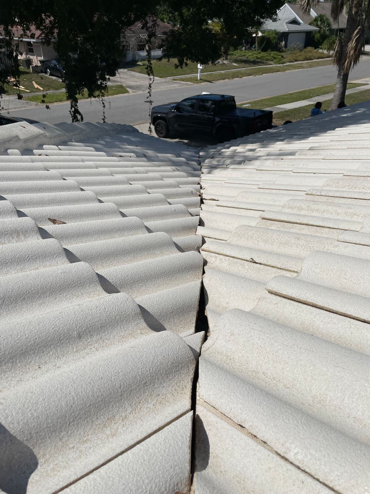 The same white tile roof after soft washing, bright and clean