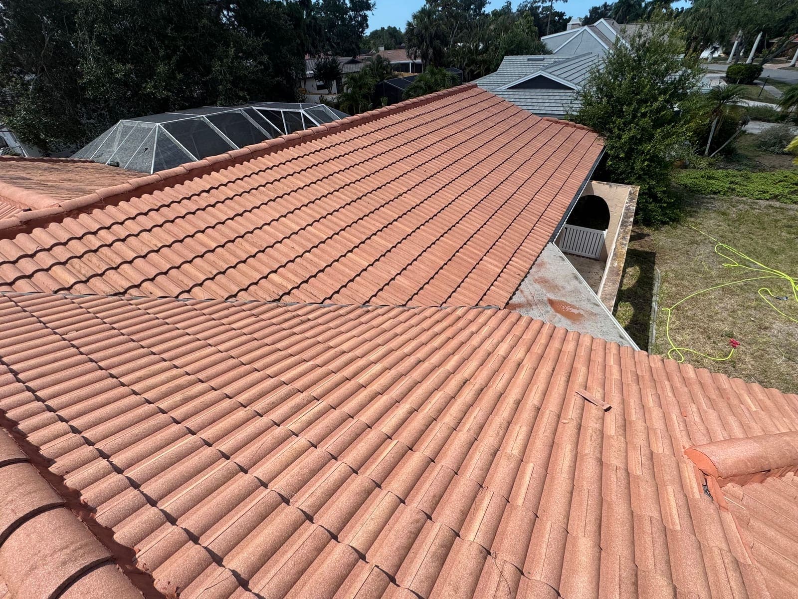 The same terracotta roof after soft washing, bright and clean